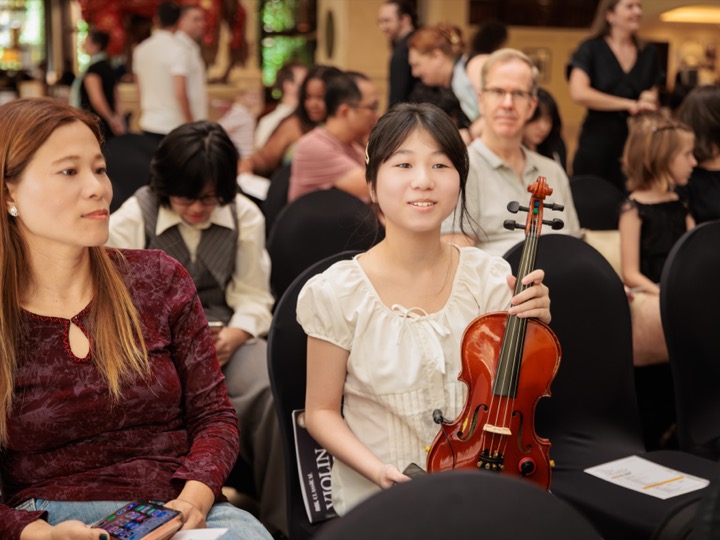 Young violinist with family