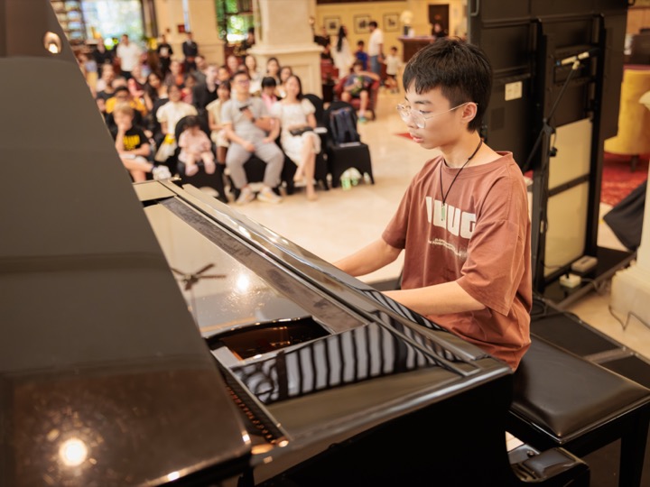At the grand piano